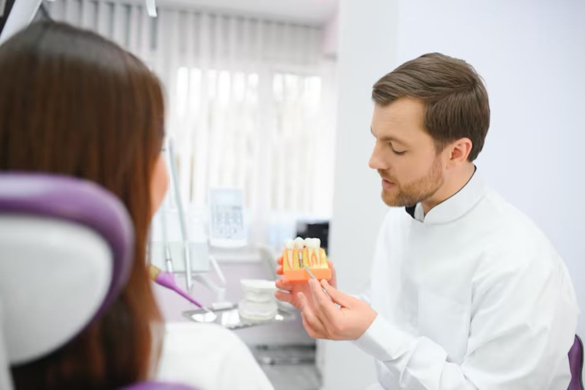 dentist discussing whether a dental crown or tooth removal is the right treatment option for a patient.